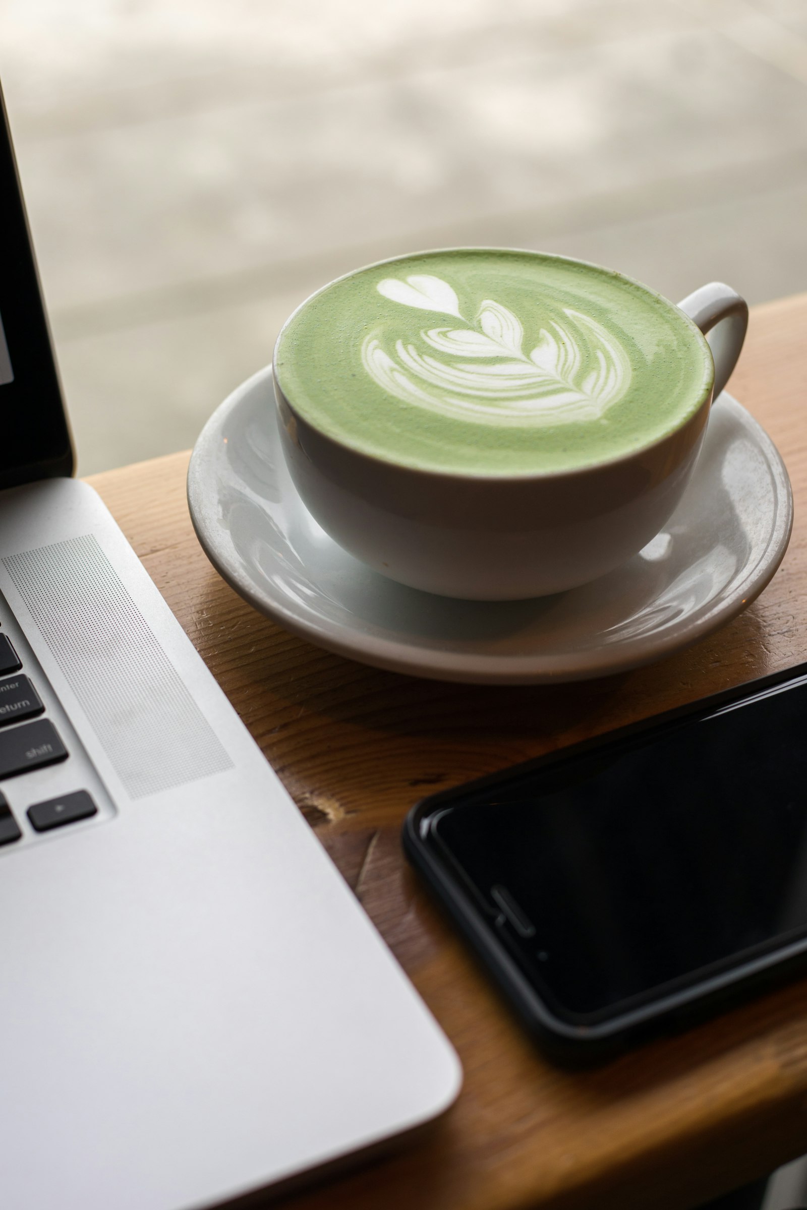 A freshly whisked matcha latte in a ceramic cup